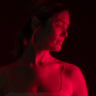 woman undergoing red light therapy on face