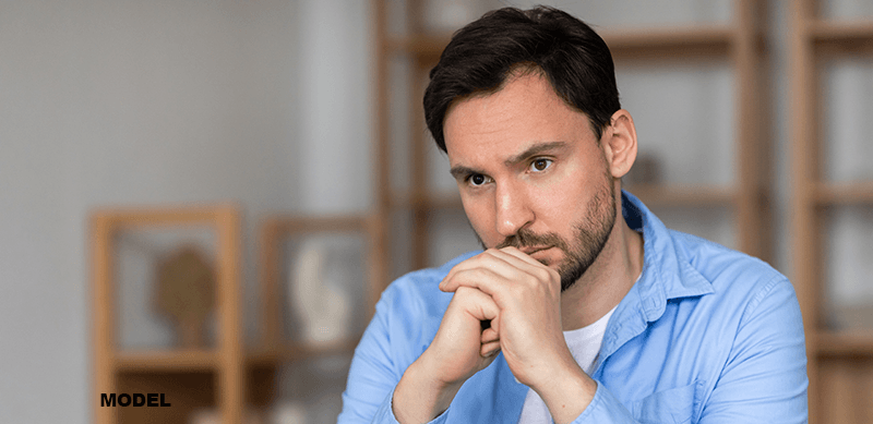 male model with thinning hair and thinking expression