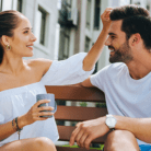 woman model running fingers through male model hair