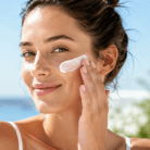 thumbnail image woman applying suncreen to face